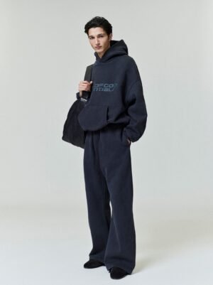 Front, back, and 90s logo detail views of the authentic 520gsm pigment-dyed black Essentials hoodie, featuring vintage wash texture, managed by Zizzle LLC.