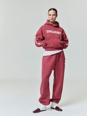 Detailed lifestyle and close-up views of the authentic 520gsm pigment-dyed rose Essentials 90s hoodie, showcasing the premium heavyweight fleece, managed by Zizzle LLC.